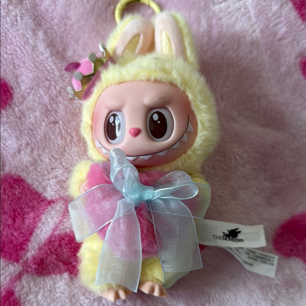 Yellow monster Pop Mart Keychain with Pink crown and heart pillow